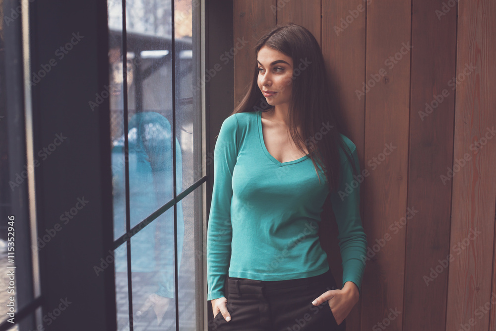 Woman is looking through window Woman is looking through window