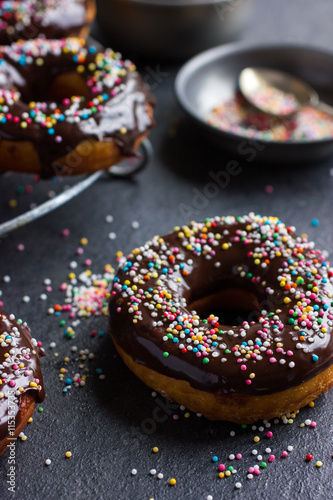 Billede på lærred fresh chocolate donuts with chocolate glaze  and colorful sprink