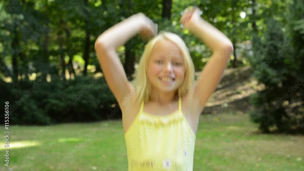 little girl rejoices in the success like a winner - eye contact - located in the park near by the park