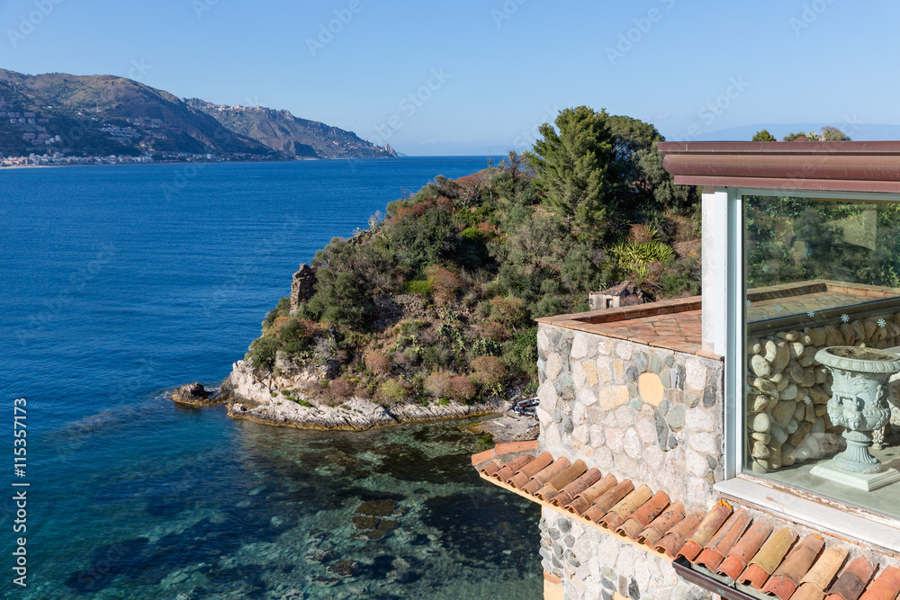 Coast of Italian island Sicily at Taormina with hotel and island