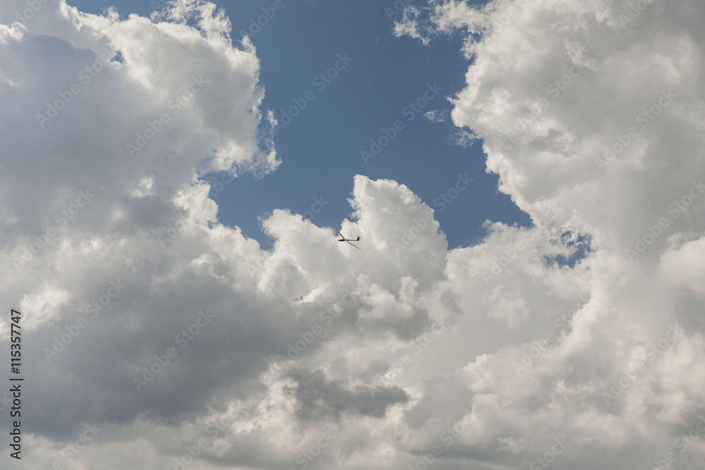 RC glider aeromodelling flying in the blue sky, white clouds background RC glider aeromodelling flying in the blue sky, white clouds background