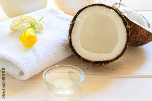 Coconut, body oil and towel for spa concept.