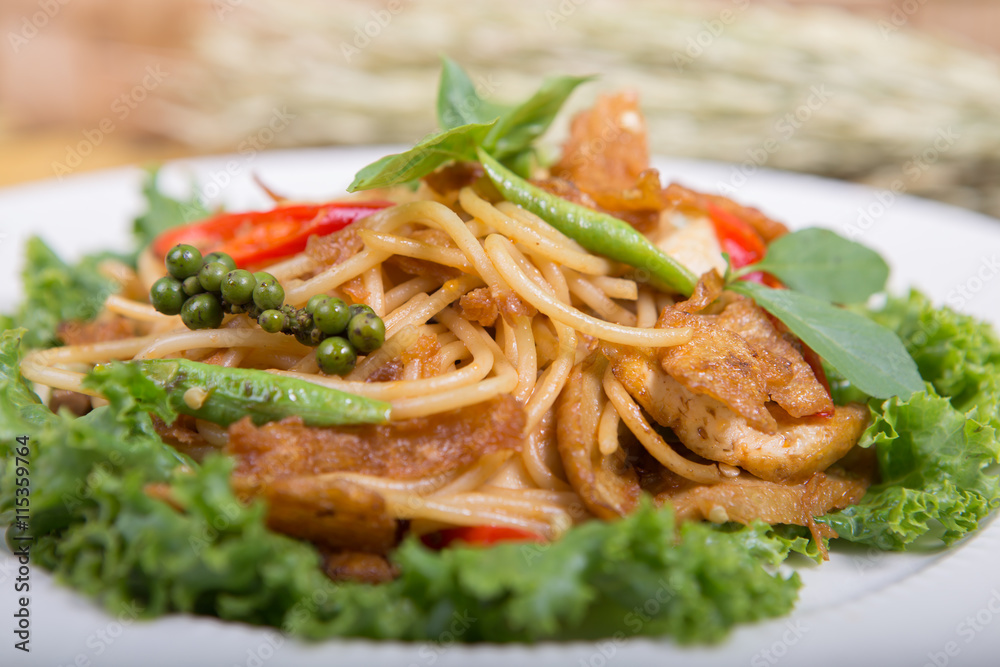 Spaghetti pasta with tomatoes and parsley on wooden table. Spaghetti pasta with tomatoes and parsley on wooden table.