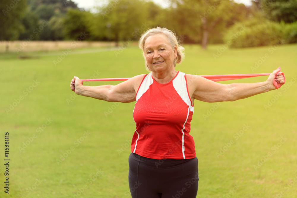 Fit senior woman using resistance bands outside Fit senior woman using resistance bands outside
