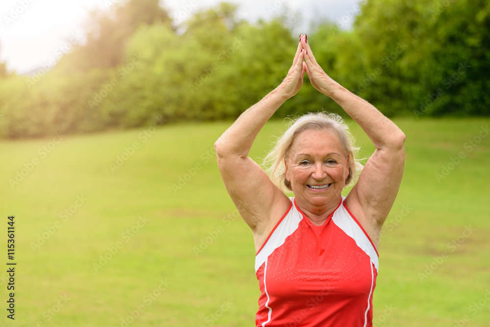 Fit senior woman performing yoga exercises