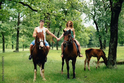 Lovers ride horses in the park