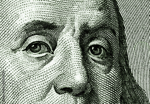 Fragment of face of Benjamin Franklin from the portrait of USA one hundred dollar note photo