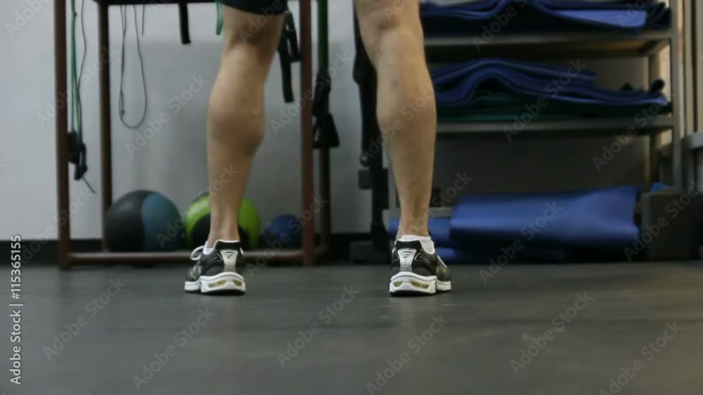Close up of legs of of boxer wich performs exercises with a punching bag Close up of legs of of boxer wich performs exercises with a punching bag