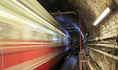 Canvas Print Gloomy metro tunnel view with moving train