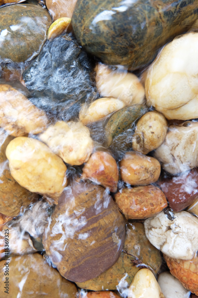 Round stones in a mountain river background Round stones in a mountain river background
