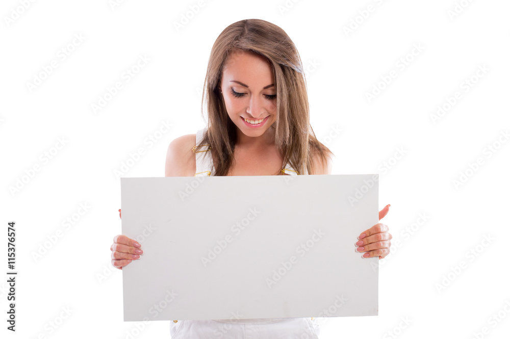 Beautiful sexy brunette girl in jeans shorts with a white sheet of paper isolated on white background. Beautiful young woman posing in studio smiling. Space for text. Beautiful sexy brunette girl in jeans shorts with a white sheet of paper isolated on white background. Beautiful young woman posing in studio smiling. Space for text.