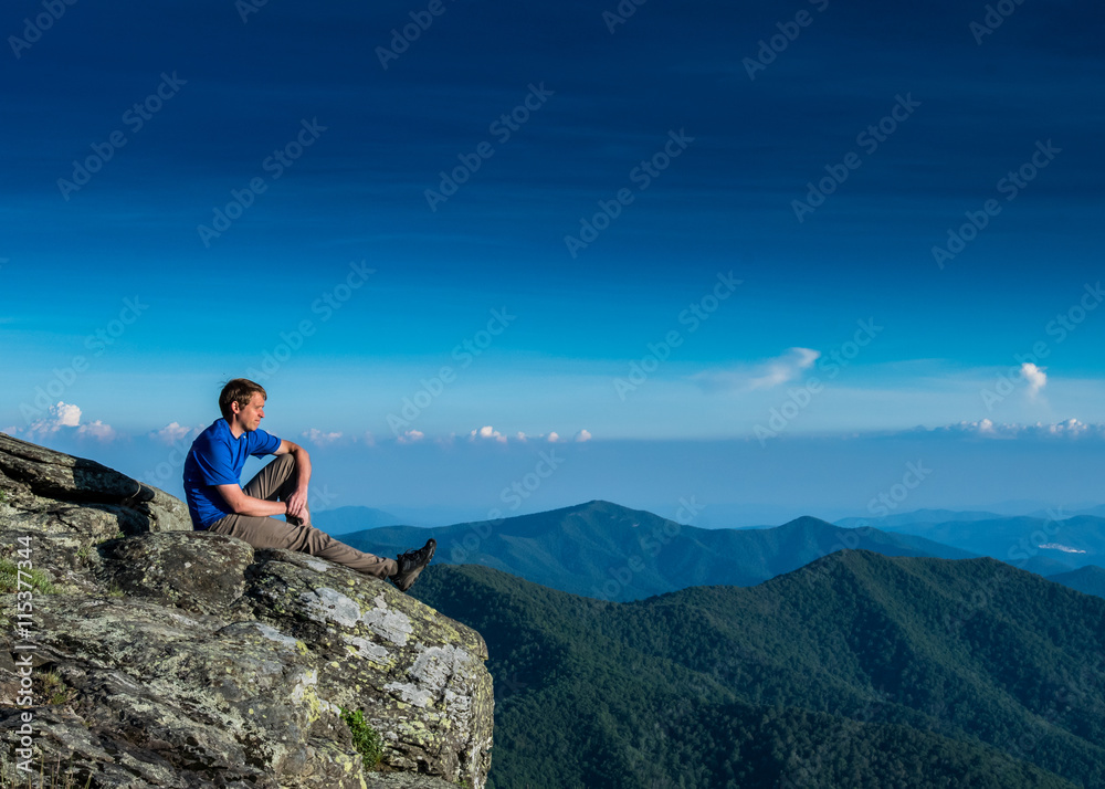 Male Soaks in the View of the Dramatic Ridge Below