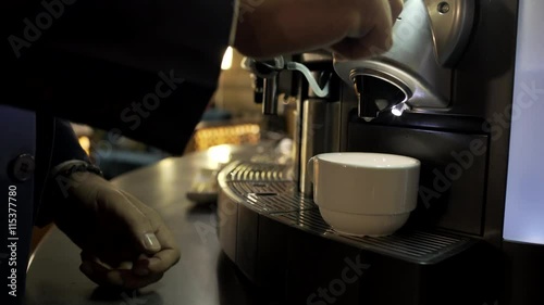 Coffee machine pouring espresso in cup