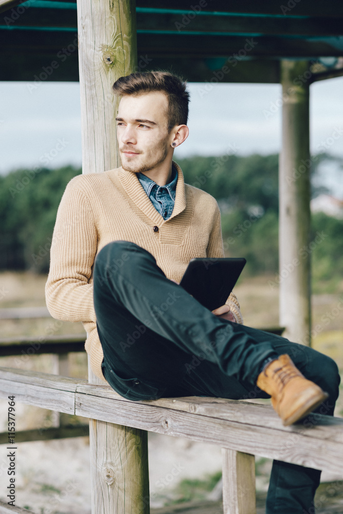 Young Man Using Technology in a Nature Setting