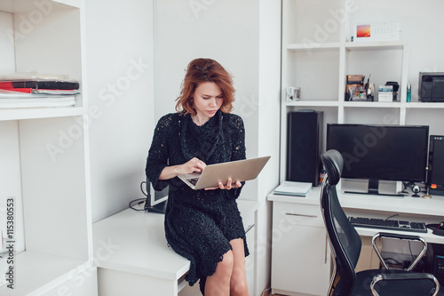 Young business woman with a computer in the office