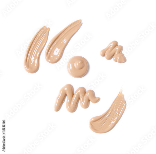 Smears of light colored foundation make up isolated on a white background