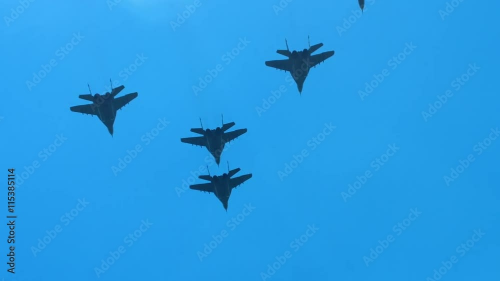 SLO MO WIDE TILT Formation of military fighter jets flying towards the horizon against blue sky. 120 FPS SLO MO WIDE TILT Formation of military fighter jets flying towards the horizon against blue sky. 120 FPS