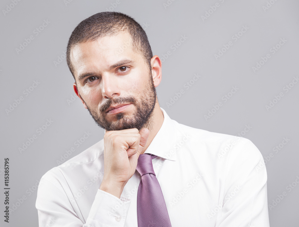 Portrait of a thoughtful business man on grey background Portrait of a thoughtful business man on grey background