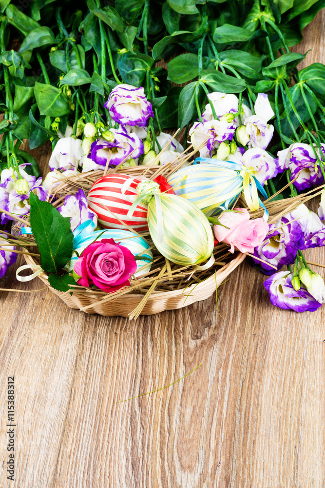 Easter eggs with flowers on wooden background