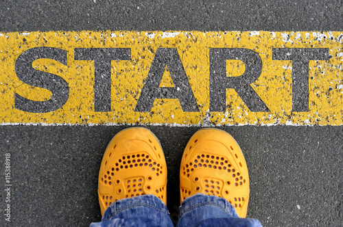 Top View of yellow shoes on the asphalt road with yellow line. G