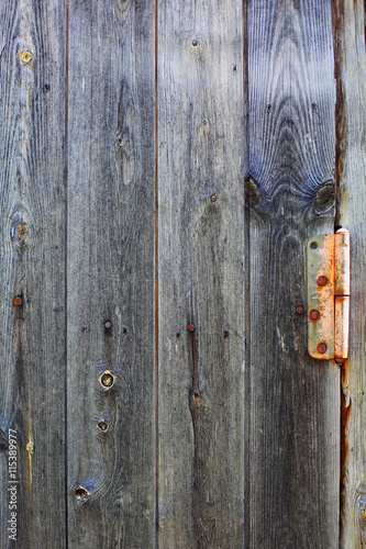 texture of old wooden boards from a door hinge
