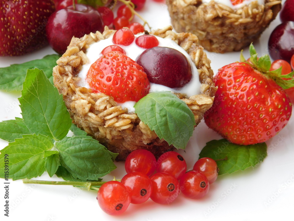 Granola cups for breakfast filled up with yougurt and berries Granola cups for breakfast filled up with yougurt and berries