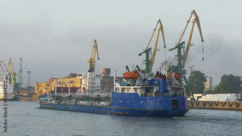 The port , Russia: work in the port, a large cargo ship, the ship in the background The port , Russia: work in the port, a large cargo ship, the ship in the background