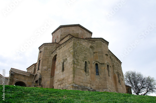 The ancient monastery Jvari on the background of the spring sky, view from below
