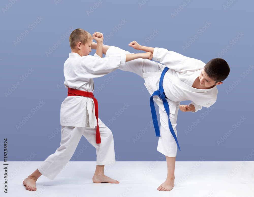 Children athletes train strikes and blocks Children athletes train strikes and blocks