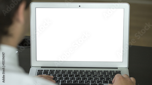 Man working on laptop in the office. White screen.