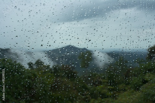 Moinsoon rain drops on the bus window glass