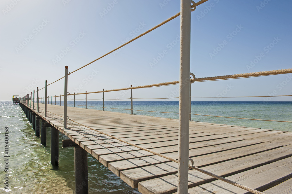 Wooden pier from beach on tropical sea