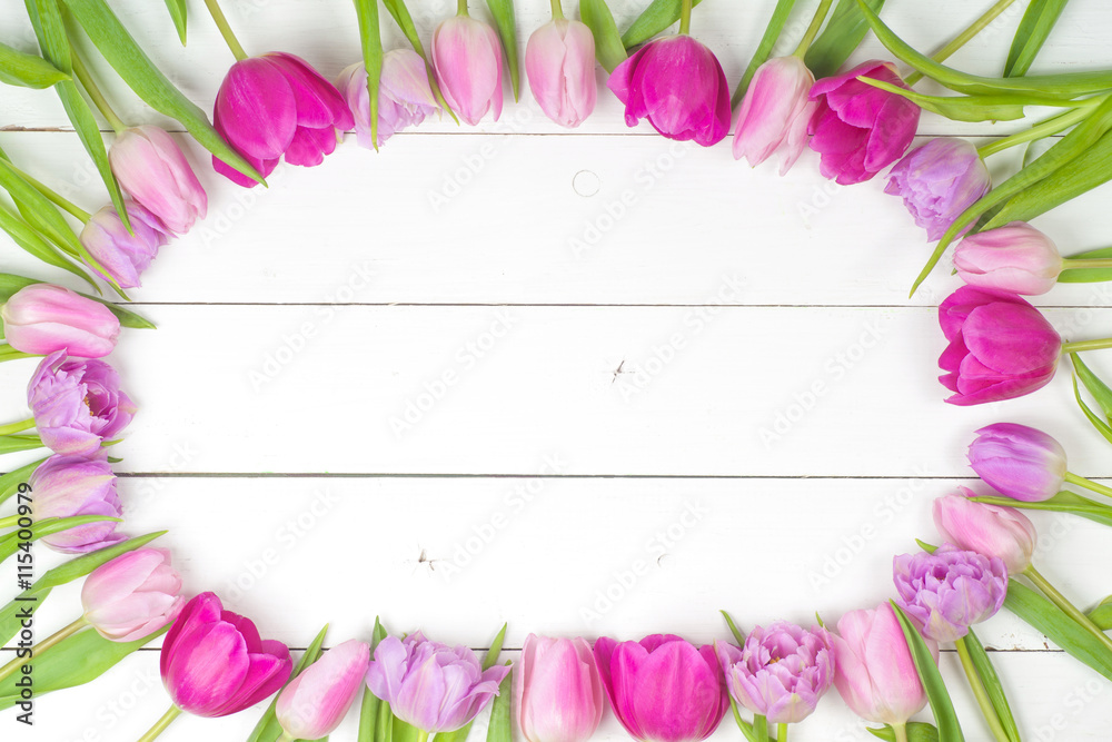 Bright, beautiful tulips on a wooden background. Top view. Copy space for text. card with flowers