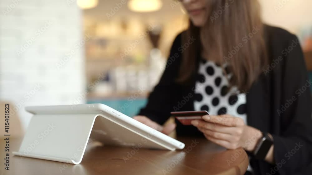 Woman shopping using tablet pc and credit card .indoor.close-up
