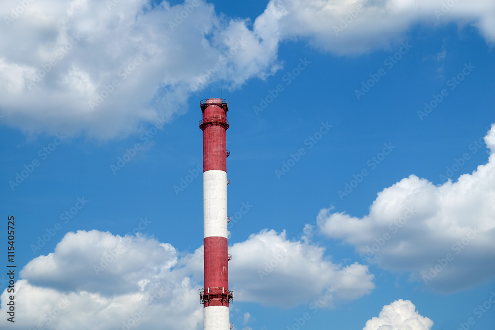 Red and white colored stripe industrial smoke pipe on blue sky with white clouds horizontal photo Red and white colored stripe industrial smoke pipe on blue sky with white clouds horizontal photo