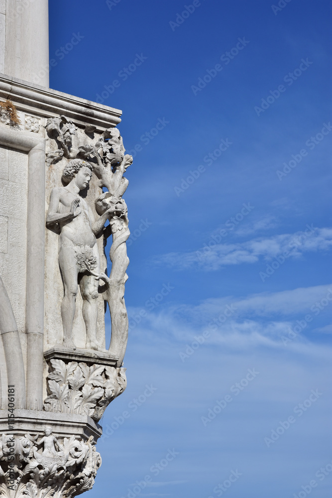 Doge Palace corner with ancient medieval sculpture of Adam and Tree of Knowledge