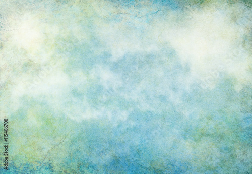 Cloud Grunge Earth. A textured background with turquoise, yellow and green grunge patterns overlaid with fog and clouds. Image displays a pleasing paper grain at 100 percent.