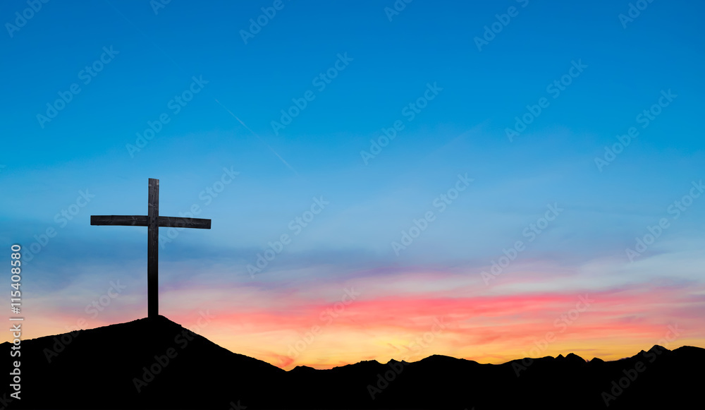 Cross on hill at sunset or sunrise