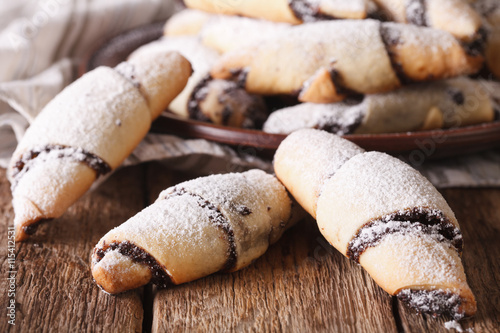 crescent rolls with poppy seeds macro on a plate. Horizontal
 photo