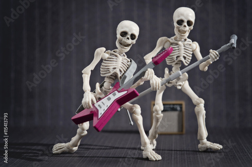Two skeleton playing rock music