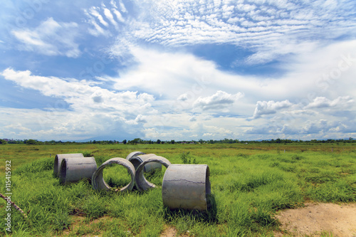 Concrete pipes on green meadow © kuarmungadd