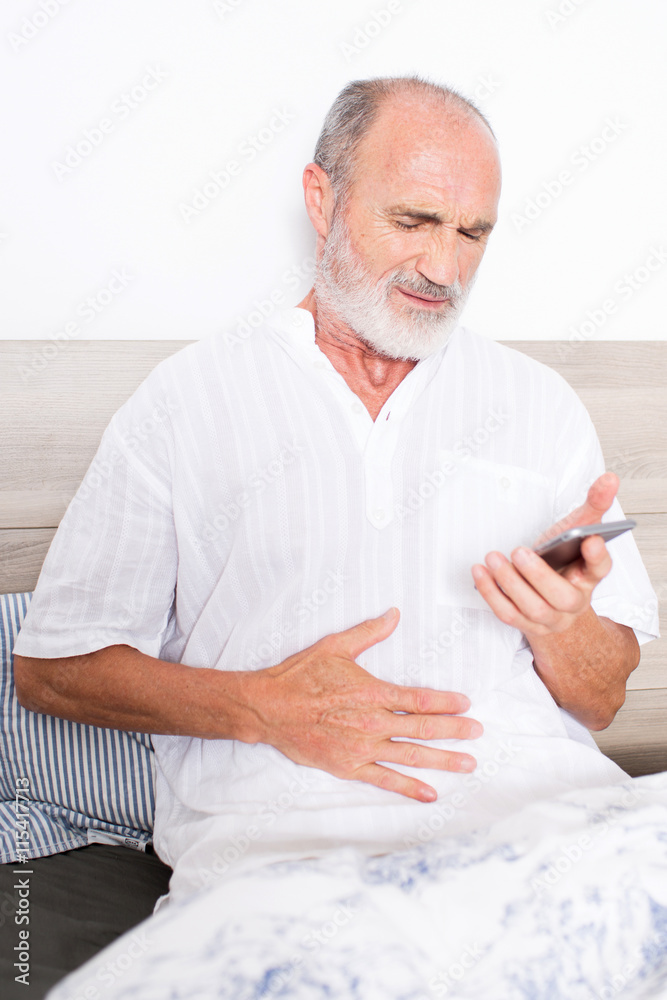 Elderly man calling the doctor with stomachache calling doctor Elderly man calling the doctor with stomachache calling doctor