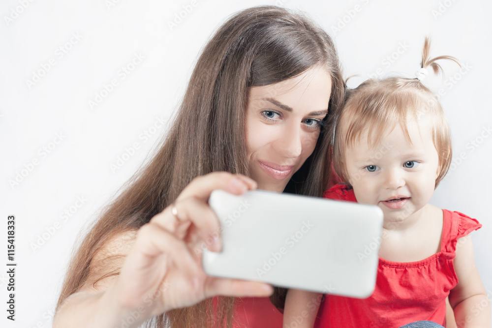 Funny baby and mother make selfie on mobile phone Funny baby and mother make selfie on mobile phone