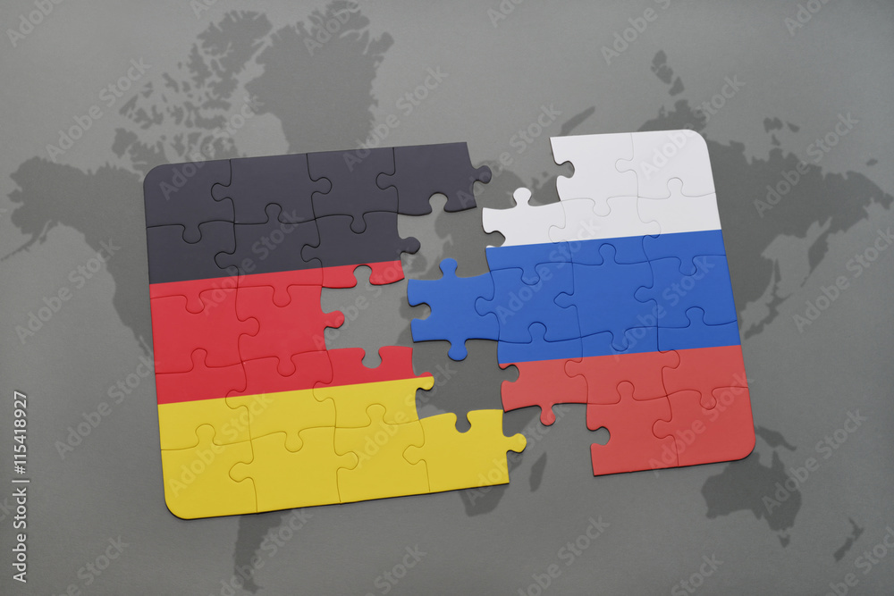 puzzle with the national flag of germany and russia on a world map ...