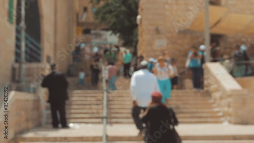 Blurred anonymous crowd of people walking in the street in the old city of Jerusalem Israel.