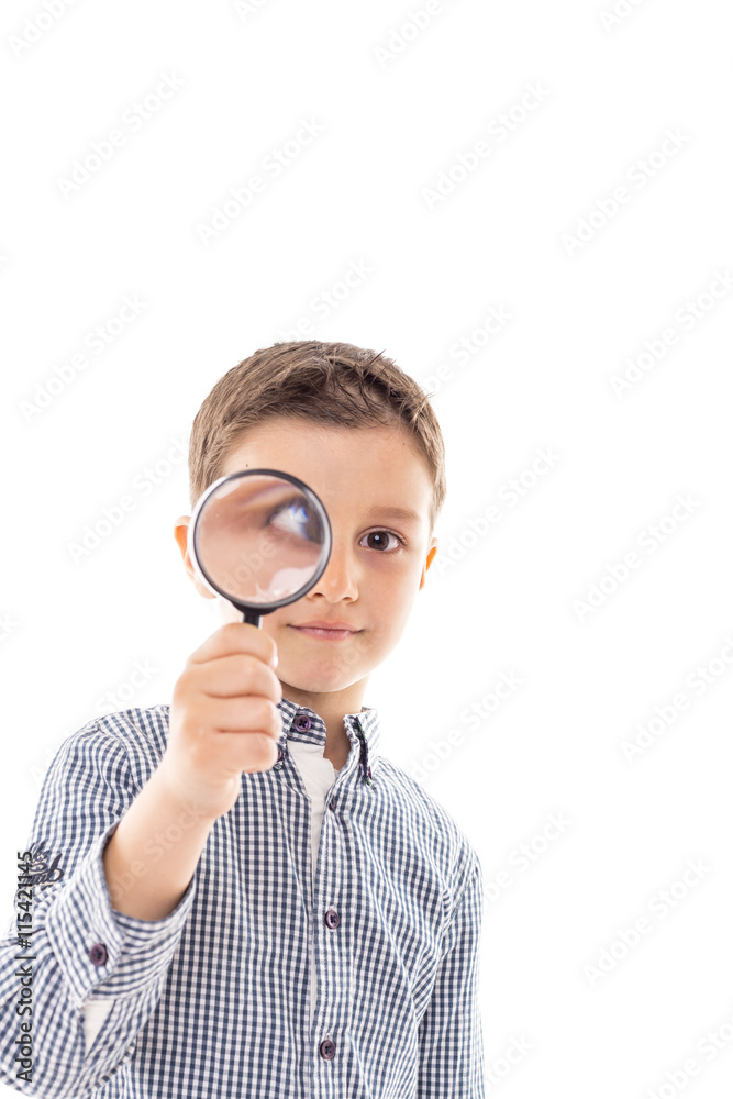 Closeup of a beautiful child looking through a magnifying glass Closeup of a beautiful child looking through a magnifying glass