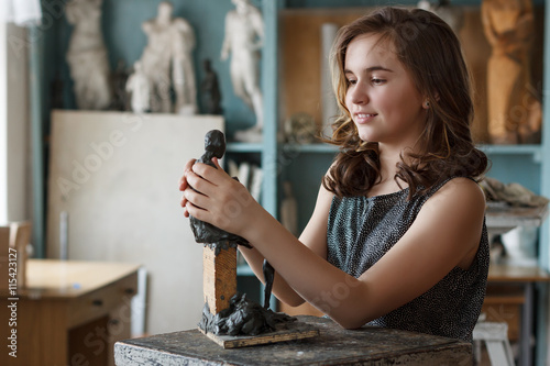 Teen Girl molds from clay sculpture in the artist's studio.