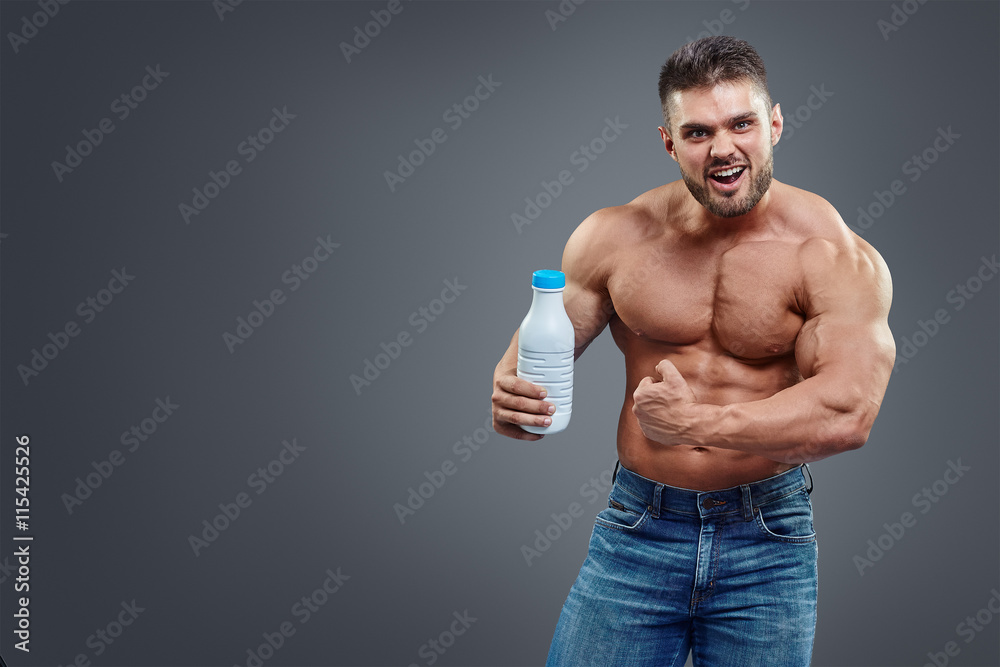 athletic young handsome man with white shake bottle.