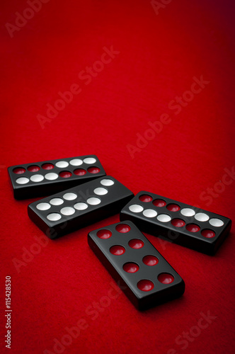 Chinese dominos on a red felt table background in the vintage casino game of Pai Gow tiles © Victor Moussa