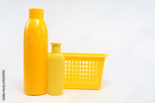 Yellow plastic jars and container on a white background